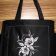 Black bag embroidered with flower