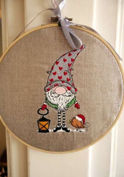 Embroidered Christmas gnome in wooden frame.
