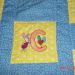 Small embroidered Piglet letter C design on quilt