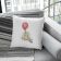 square pillow with winnie pooh embroidery design featuring grey fabric couch