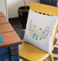 square pillow with summer meadow embroidery design