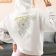 back view hoodie with dreamcatcher dandelion embroidery design woman in a cozy outfit making a peace.jpg