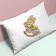 throw embroidered pillow resting against multicolored surface