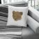 Square embroidered pillow featuring a grey fabric couch