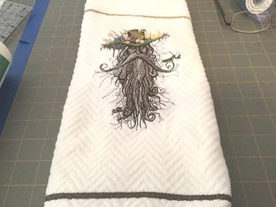 Towel with Root man machine embroidery design
