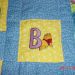 Happy embroidered Winnie pooh letter B design on warm quilt
