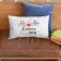 pillow with MR & MRS Arrows Wedding est embroidery design featuring books over wooden sofa with- eather cushions