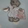 Tatty teddy bear on embroidered polka dot table cloth