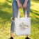 woman holding tote bag with hello fall embroidery design
