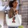 curly haired woman with a embroidered tote bag