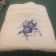 Bath towel with blue flower free embroidery design