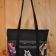 Embroidered black textile bag with Maleficent on it