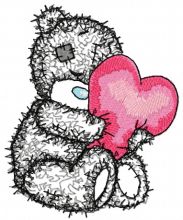 Teddy bear with a pillow in the form of heart applique