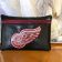 Leather case with red wings logo embroidery design