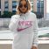 woman with a pullover hoodie with nike barbie embroidery design
