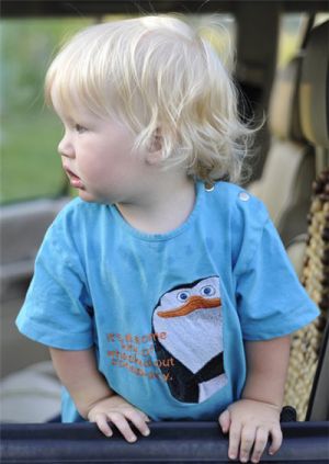 Embroidered penguin from Madagascar on blue t-shirt