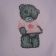 White t-shirt with embroidered blue nose teddy bear on it