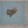 Blue napkin with embroidered teddy bear on it