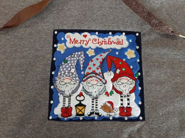 Sweater with embroidered christmas patch with design