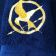 Embroidered Hunger games logo design on towel