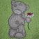 Teddy bear with flower chamomile on embroidered towel