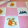 Pink and white embroidered quilt with Pooh designs