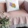 Embroidered squared pillow on a relaxing couch