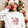 happy girl wearing sweatshirt with santa claus embroidery design