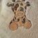 White bath towel with embroidered giraffe on it