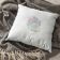 pillow with christmas reindeer free embroidery design lying on a gray blanket
