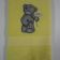 Embroidered yellow towel with tatty teddy on it