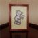 Embroidered Teddy bear with chamomile design in frame