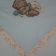 Teddy bear with rattle design embroidered on napkin