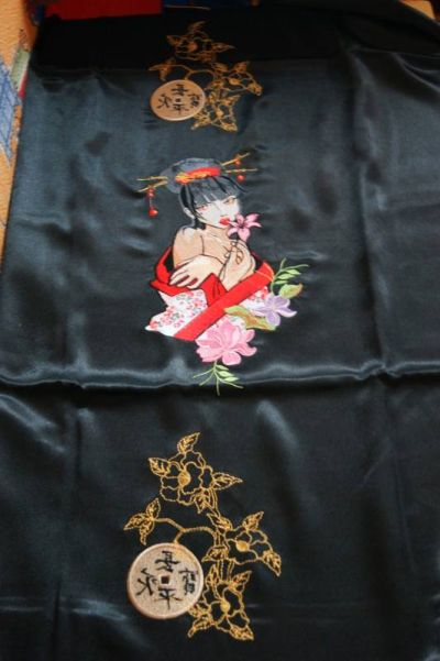 Modern geisha with flower on embroidered bed cover