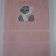 Pink towel with blue nose teddy bear design embroidered on it
