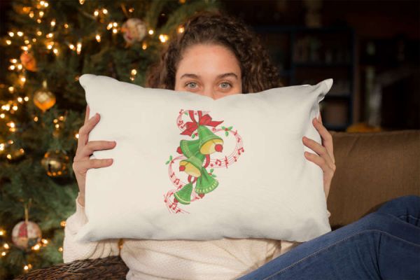 Embroiered pillow of a beautiful girl holding a pillow with a christmas