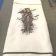 Embroidered towel with root man design