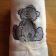 Sad tatty teddy bear on white bath towel